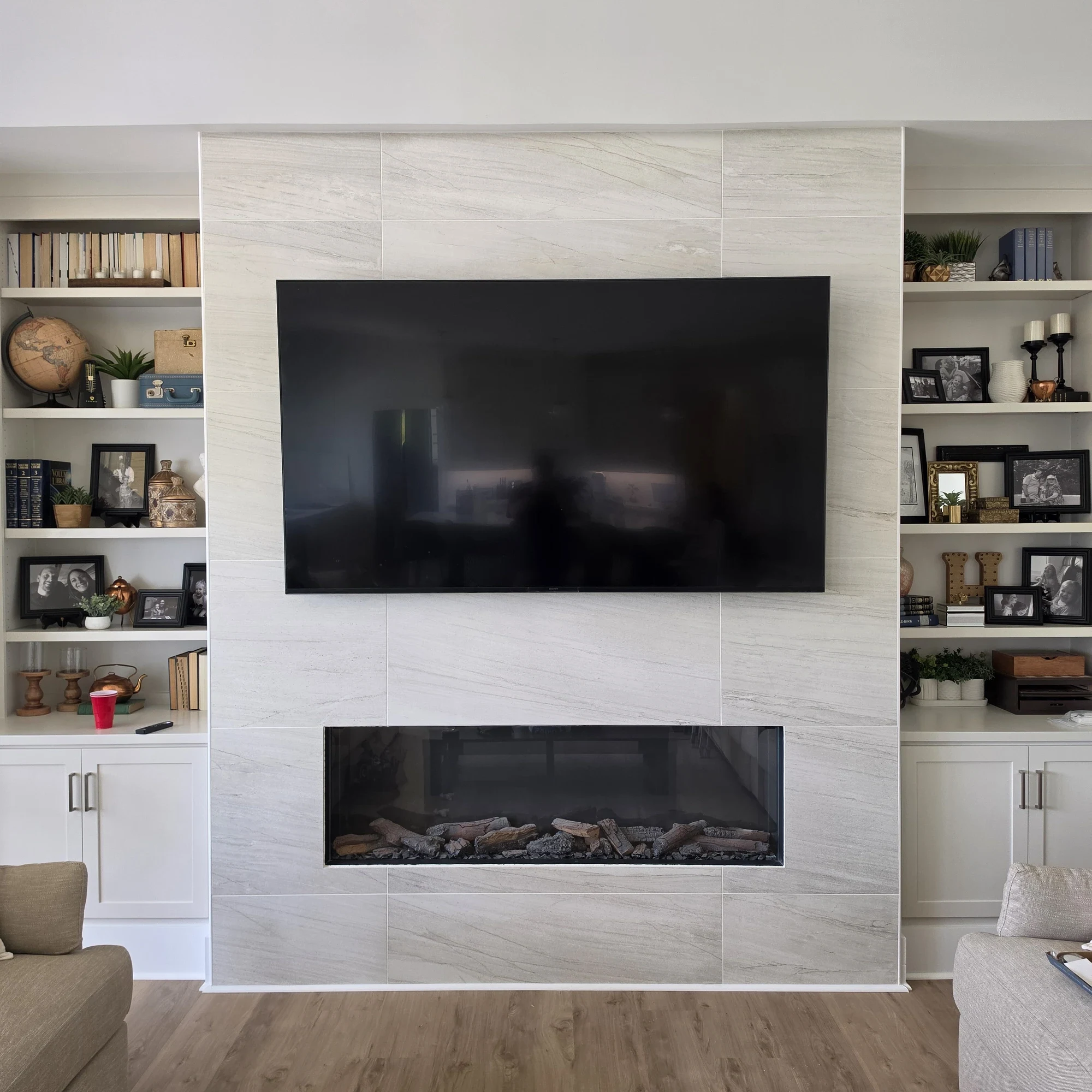 Large TV mounted above a tiled fireplace, installed by Set Up Home Theater